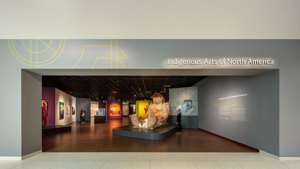 Interior of a museum gallery with exhibits on Indigenous Arts of North America