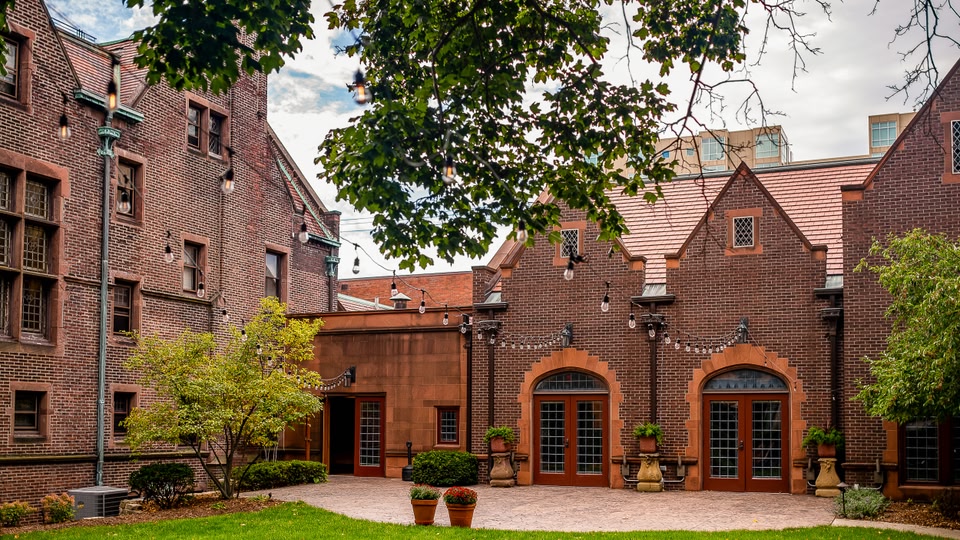 Aerial view of a cityscape with a large group of swimmers participating in an event in the foreground.