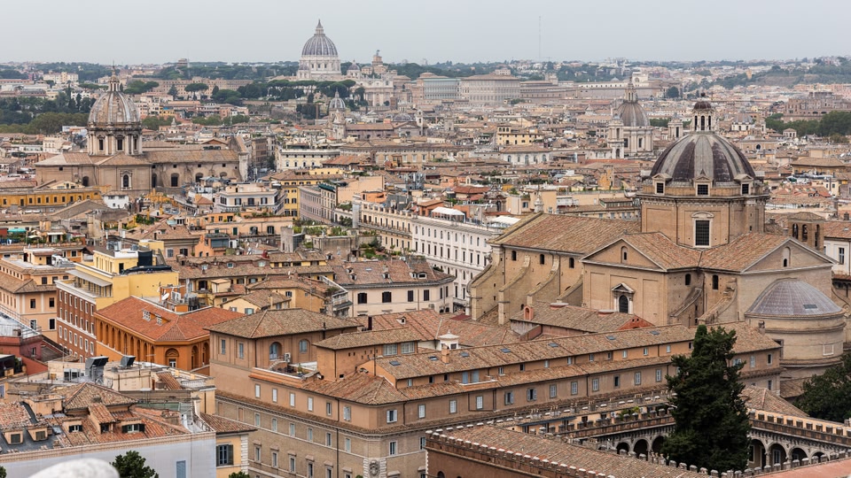 Aerial view of Rome, Italy, showcasing a skyline with numerous historical buildings and landmarks.