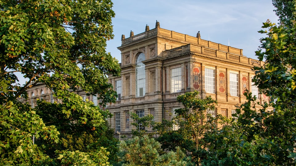 A historic building in Dusseldorf, North Rhine-Westphalia, Germany, surrounded by trees.