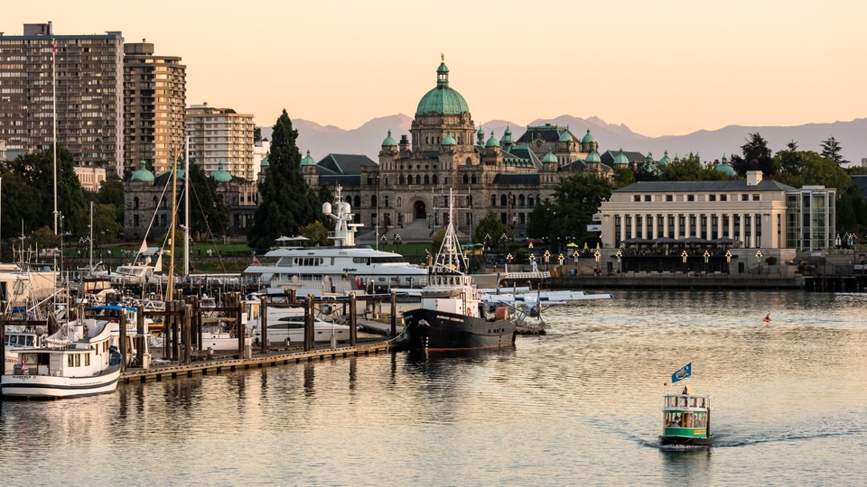 The Empress Hotel in Victoria, British Columbia, Canada, illuminated at night with a waterfront view.